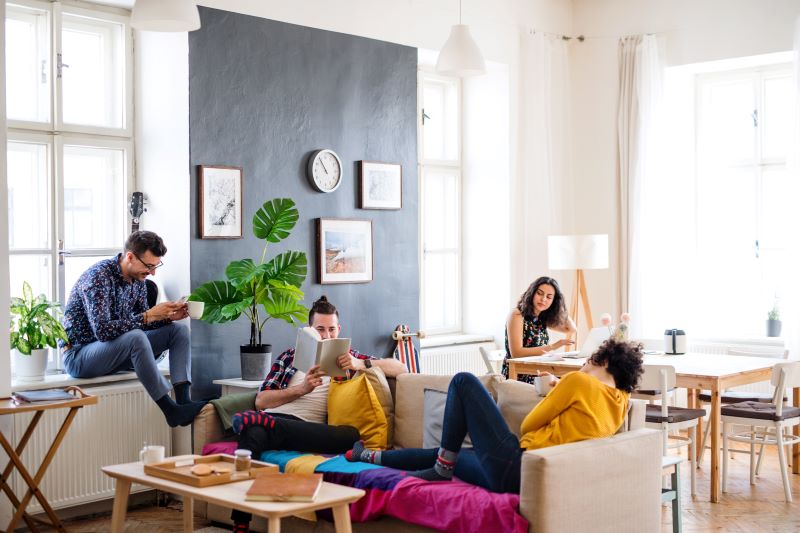 Students relaxing in a modern apartment, showcasing the comfort and style of ideal student living spaces.