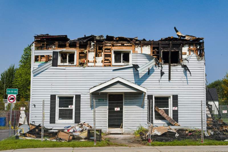 A house severely damaged by fire, showing the impact of fire damage and the need for restoration services.