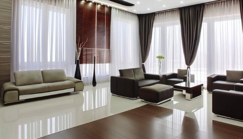 A modern living room featuring sleek furniture and premium window treatments, including stylish curtains and blinds that enhance the room’s aesthetic and functionality.