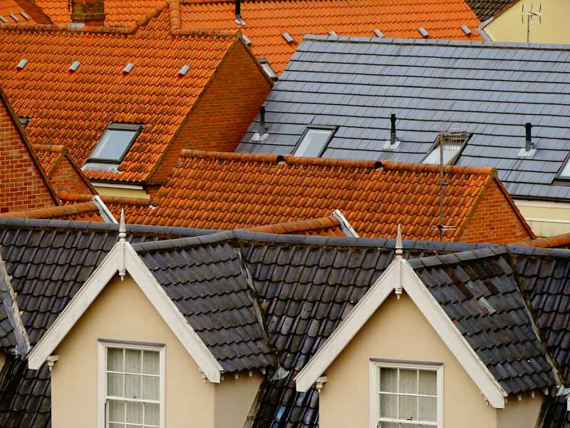 Various roofing systems, including tiled and shingle roofs, showcasing different types of materials commonly used for commercial buildings.