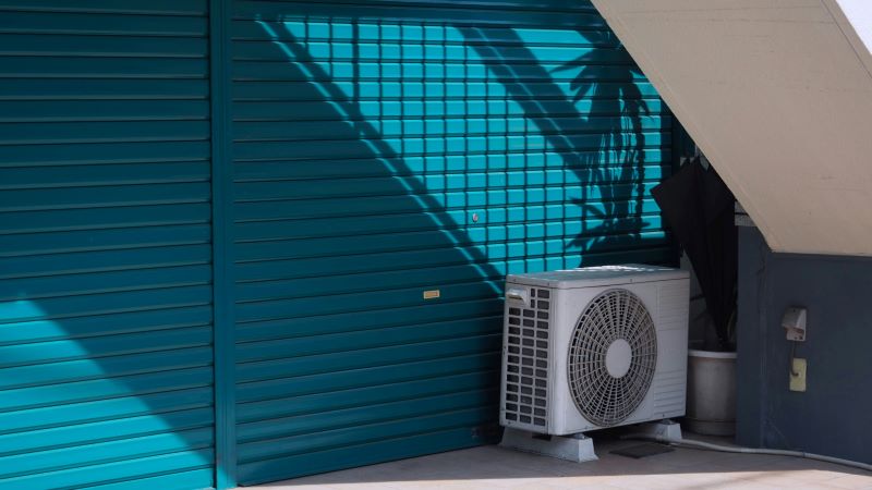 A well-maintained air conditioning unit installed on a building exterior, showcasing proper placement for efficient cooling and minimal wear.