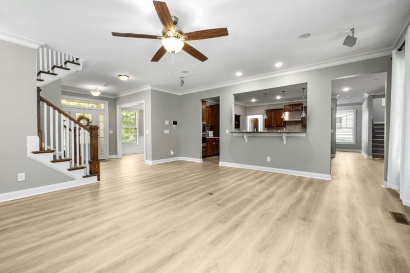 Ceiling fan design in a modern open-plan living room, enhancing airflow for effective spot cooling.
