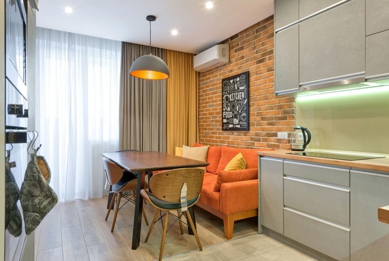 Modern kitchen and dining area with a visible HVAC system mounted above a brick wall, showing the integration of an HVAC system for efficient indoor climate control.