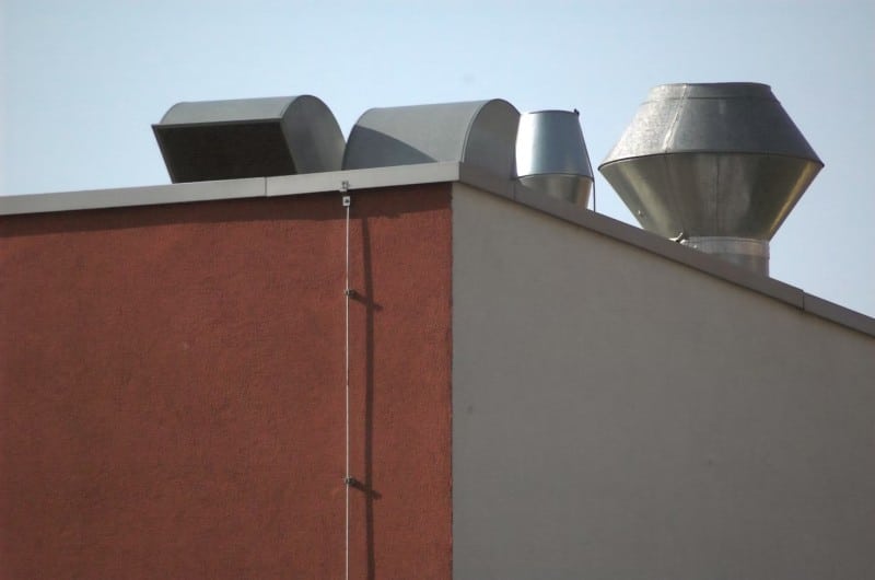 Rooftop HVAC ventilation units on a commercial building, essential for maintaining proper indoor air quality in business spaces.