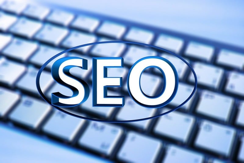 SEO Phoenix text overlay on blurred computer keyboard, symbolizing digital marketing and search engine optimization for construction businesses.