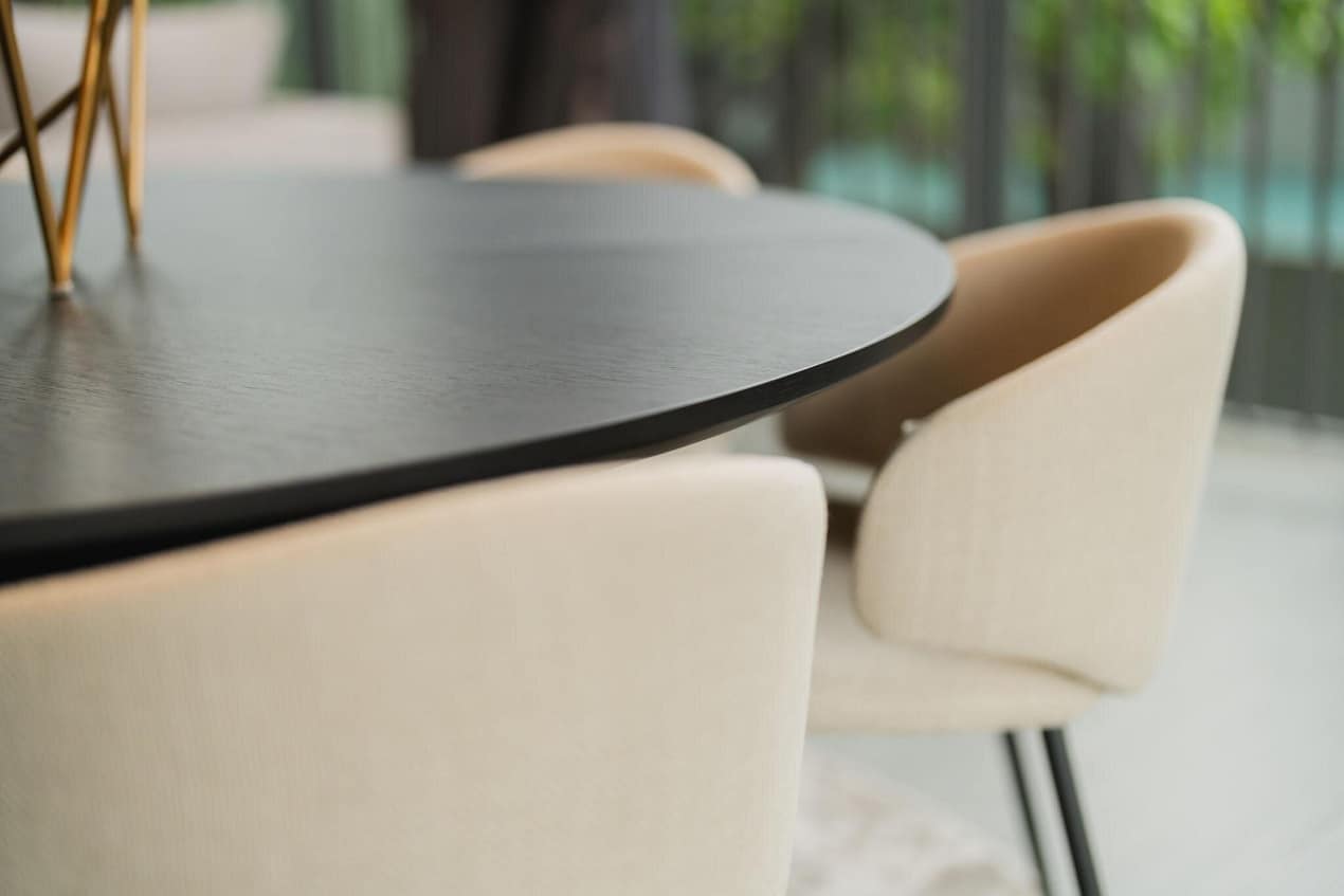 Dining table and upholstered chairs showing proper chair height, table clearance, and comfortable dining room seating.