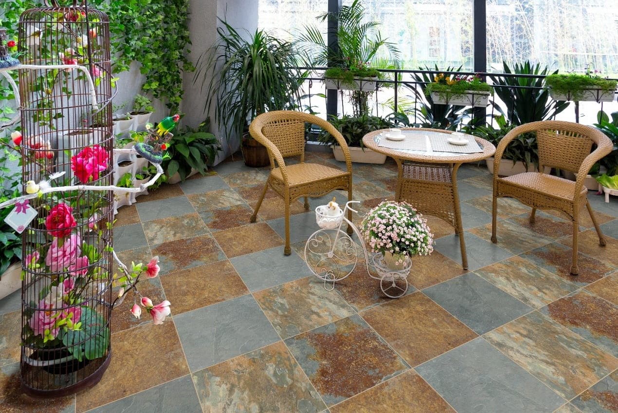 Sunroom with natural slate floor tile in warm earth tones, showing proper slate floor care and finish