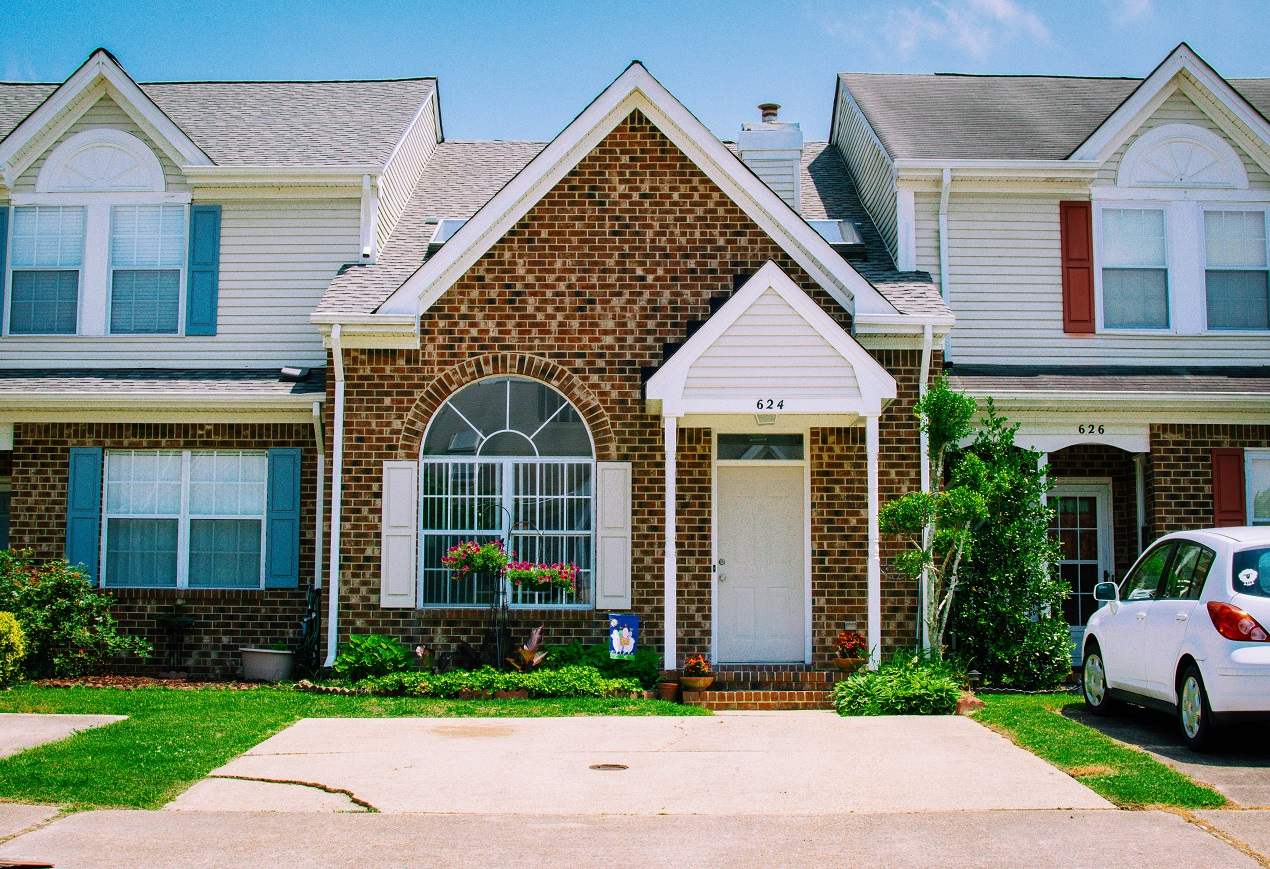 Well-maintained brick townhouse with landscaped entry, ideal for hosts managing a short-term rental property